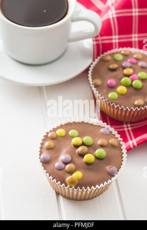 Sweet cupcakes with candies and coffee cup. Stock Photo