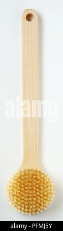 Back scrubber, with wooden handle and round head. Stock Photo