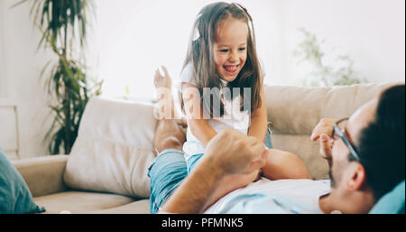 Portrait of father and daughter playing at home Stock Photo