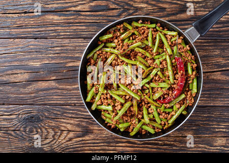 Szechuan Stir Fried Green Beans with ground pork in a skillet, view from above, close up Stock Photo