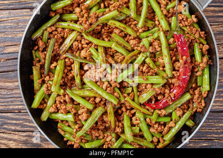 Pork Stir Fry with Green Beans in a skillet, Szechuan recipe, view from above, close up Stock Photo