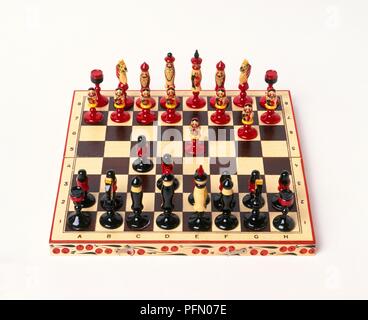 Chess board made from wood with chess pieces in the style of matryoshka dolls Stock Photo