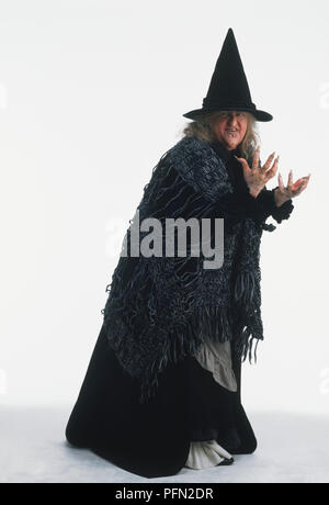 Adult dressed in witch costume, looking at camera Stock Photo