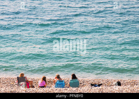 Chesil Beach. 21st August 2018. Two males enjoy swimming off Chesil Beach,  Portland, in Dorset, the