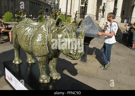 London, UK. 2 1 August 2018. A.D's Rhino Eterno painted by Adam Dant, outside the Royal Exchange, part of the 21 Tusk Rhino Trail installations on display in London. The rhinos, embellished by the internationally renowned artist will be on display until World Rhino Day on 22 September to raise awareness of the severe threat of poaching to the species' survival. They will then be auctioned by Christie's on 9 October to raise funds for the Tusk animal conservation charity. Credit: David Mbiyu / Alamy Live News Stock Photo