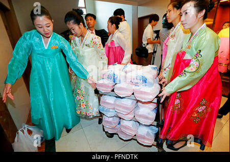 Inter-Korean Family Reunion, Aug 21, 2018 : North Korean hotel workers carry lunch boxes to distribute them to hotel rooms where South Koreans are meeting their North Korean relatives during an inter-Korean family reunion at Oekumgang hotel in Mt. Kumgang resort, North Korea in this picture taken by Joint Press Corps at Mt. Kumgang and handouted by the South Korean Ministry of Unification. Eighty-nine elderly South Koreans crossed the Demilitarized Zone separating the two Koreas along the eastern coast of Korean peninsula on August 20 to meet their North Korean relatives for the first time sin Stock Photo