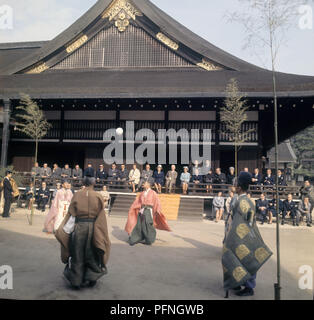 German President Heinrich Lubke (M, brown suit) and his wife Wilhelmine (left next to him, blue costume) in Kyoto as a spectator of an old Japanese football game, which was held in traditional clothing. | usage worldwide Stock Photo