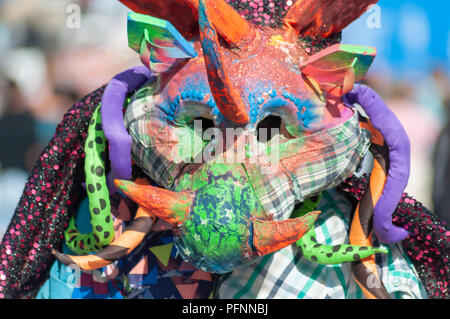 Edinburgh, Scotland, UK. 22nd August, 2018. A male dance artist from 2Faced Dance Company dressed in a dragon costume performs a fringe show for children called What The Moon Saw, a production inspired by Hans Christian Anderson on the Royal Mile during the last week of the Edinburgh Fringe Festival. Credit: Skully/Alamy Live News Stock Photo