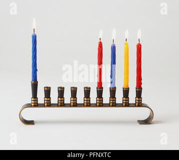 Five lit Hanukkah candles on a menorah Stock Photo