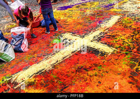 Antigua, Guatemala -  April 2, 2015: Dyed sawdust Holy Thursday procession carpet in UNESCO World Heritage Site with famous Holy Week celebrations. Stock Photo