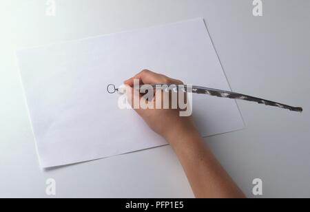 Hand using quill pen, close-up Stock Photo
