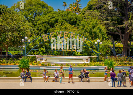 Los Angeles, California, USA, AUGUST, 20, 2018: Outdoor view of unidentified people taking pictures and posing in front of Beverly Hills sign and fountain Stock Photo