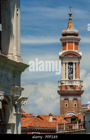 Church of the Holy Apostles of Christ baroque bell tower with clock, built between 17th and 18th century, rise above Venice historic center old buildi Stock Photo