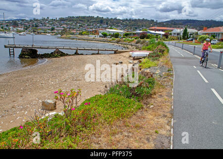 Cyclist on the Clarence Foreshore Trail in Hobart Stock Photo