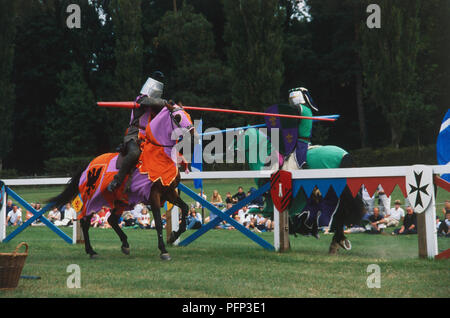 Two knights on horseback jousting Stock Photo