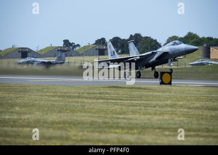 An F-15C Eagle assigned to the 493rd Fighter Squadron takes off at Royal Air Force Lakenheath, England, during Exercise POINTBLANK May 24, 2018. The objective for this iteration is to prepare Coalition warfighters, consisting of 10 F-15E Strike Eagles, 10 F-15C Eagles from the Liberty Wing and four RAF Eurofighter Typhoons for a highly contested fight against near-peer adversaries by providing a multi-dimensional battle-space to conduct advanced training in support of U.S. and U.K. national interests. Stock Photo