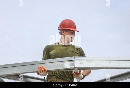 U.S Marine Corps Reserve Lance Cpl. Cole Smith, 346th Air Expeditionary Group combat engineer who is deployed from Peoria, Ill., lifts a roofing truss May 21, 2018 at a construction site in Meteti, Panama. Smith is participating in Exercise New Horizons 2018, which is a joint training exercise where U.S. military members conduct training in civil engineer, medical, and support services while benefiting the local community. Stock Photo