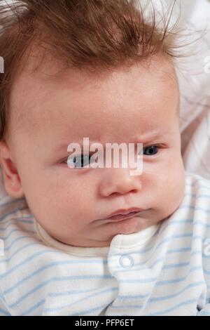 Tired 11 week old baby boy Stock Photo