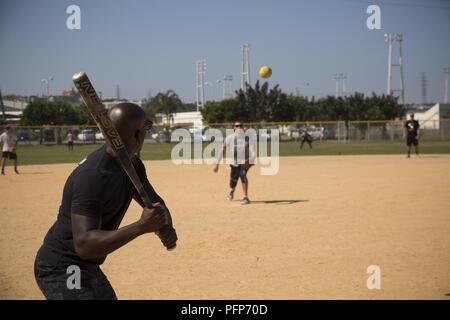 Cpl. Akyng Franklin prepares to swing during the Marine Wing Headquarters Squadron 1 Command Softball Tournament at Camp Foster, Okinawa, Japan, May 25, 2018. The commander’s intent for the tournament is to measure physical fitness, build unit cohesion and establish official bragging rights of the Commanders Cup. Stock Photo