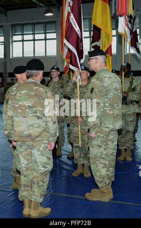 Command Sgt. Maj. Joseph Cecil, Regional Health Command Europe, prepares to pass the Regional Health Command Europe colors to outgoing commander, Brig. Gen. Dennis LeMaster during a Change of Command Ceremony, May 23, 2018 at Sembach Kaserne, Germany Stock Photo