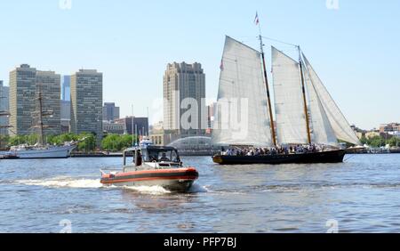 Coast Guard assets from Coast Guard Sector Delaware Bay and the Coast Guard Auxiliary in Philadelphia enforce a safety zone for the parade of sail for Sail Philadelphia 2018 as tall ships from around the world transit the Delaware River in Philadelphia, May 24, 2018. Ships will be docked along the Delaware River Waterfront from Market Street to the end of the Penn’s Landing Marina. Stock Photo