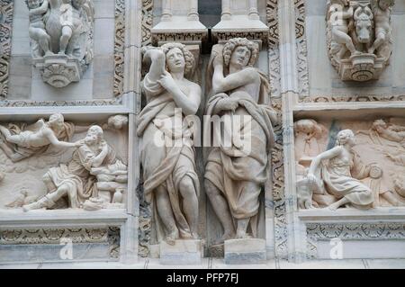 Italy, Lombardy region, Milan city, Duomo di Milano (Milan Cathedral), marble statues and relief carvings on facade Stock Photo