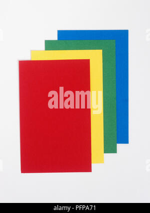 Sheets of coloured paper, blue, green, yellow, red Stock Photo
