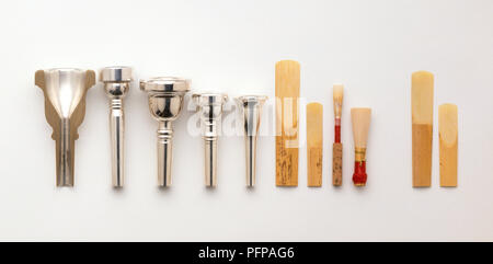 Silver mouthpieces and wood reeds for Bassoon, Clarinet, Cornet, Flugelhorn, French Horn, Saxophone, Trombone, Trumpet, and Tuba, close-up Stock Photo