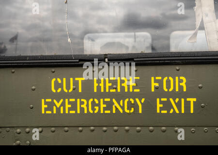 Emergency exit sign on the side of jet aircraft Stock Photo