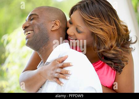 Woman hugging man, smiling Stock Photo