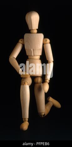 Wooden articulated artist mannequin, kneeling Stock Photo - Alamy