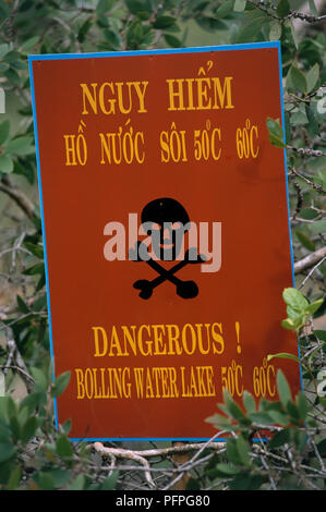Water temperature warning sign in bushes at Binh Chau Hot Springs, Vietnam Stock Photo