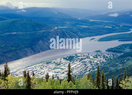 Canada, Dawson City, town on Yukon River seen from above on overcast day Stock Photo