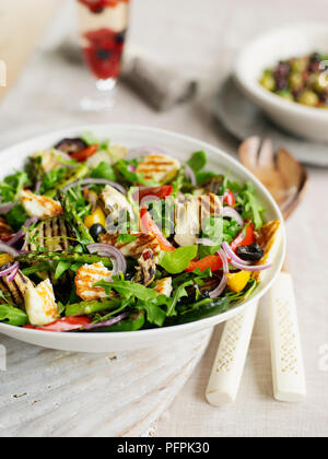 Salad with asparagus, grilled halloumi cheese, salmon fillet, tomatoes ...