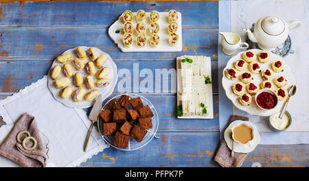 Assorted, sweet and savoury afternoon tea treats on wood background Stock Photo