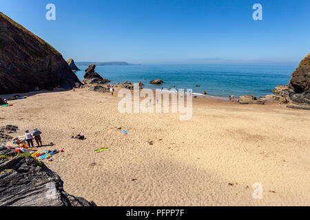 Looking across Cilborth beach, on a warm summers day towards Carreg Bica. Llangrannog, Ceredigion Stock Photo