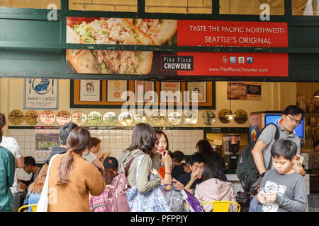 people wait in a long line to taste at the restaurant Pike Place Chowder which is very well known for their New England Clam Chowder in Seattle, USA. Stock Photo