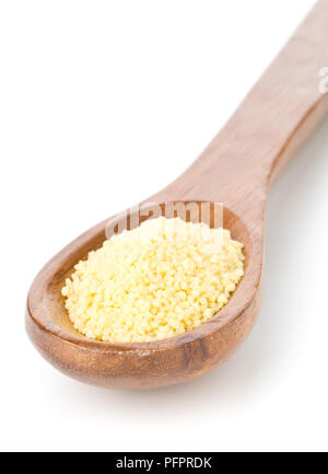 Heap of raw, uncooked couscous in wooden spoon over white background Stock Photo