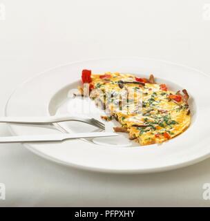 Omelette on white plate with knife and fork Stock Photo