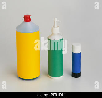 Household cleaner bottle, dispenser bottle and a glue stick Stock Photo