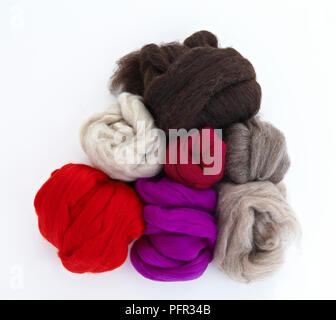 Coloured balls of wool top, coiled up and stacked Stock Photo