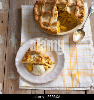 Apple pie with slice cut away and served on separate plate with ice cream Stock Photo
