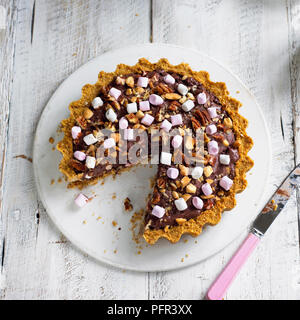 Rocky road ice-cream pie with slice missing Stock Photo