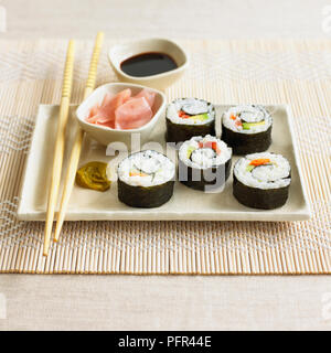 Maki sushi rolls with wasabi paste, pickled ginger and soy sauce, chopsticks (vegetarian) Stock Photo