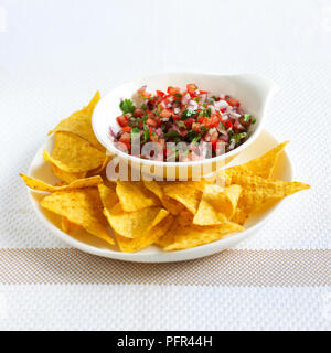 Tortilla chips with tomato, onion and coriander salsa Stock Photo