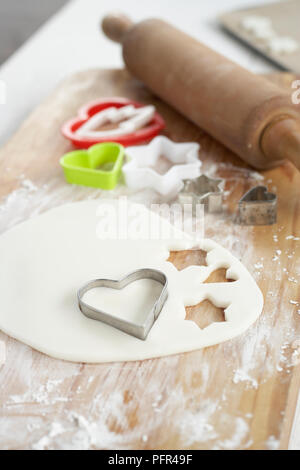 Heart shape biscuit cutter on gingerbread dough Stock Photo