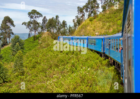 Sri Lanka, Central Province, Nuwara Eliya, train passing through mountains Stock Photo