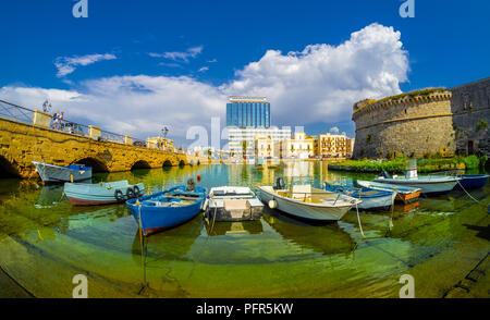 Old port of Gallipoli, cityscape view with castle and boats among Stari Grad Bridge in Puglia, Italy Stock Photo