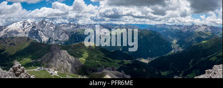 panoramic view looking down into the pass of pordoi in the italian dolomites towards canazei and campitello Stock Photo