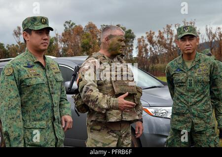 Col. Robert Ryan (center), commander, 3rd Brigade Combat Team, 25th Infantry Division, speaks to Col. Leung Shing Tai (right) commander, 6th Division, Singapore Army and Col. Andrew Lim, commander, 9th Division, Singapore Army, prior to the start of a live fire exercise for Tiger Balm 18 at Schofield Barracks, Hawaii, on May 24, 2018. Tiger Balm is a bilateral exercise held yearly between the U.S. and Singapore armies. Stock Photo